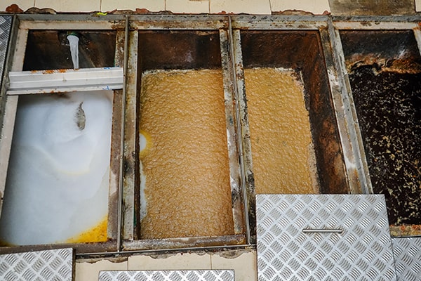 grease trap maintenance involves pumping out the accumulated grease and food waste, cleaning the traps, and inspecting for any issues